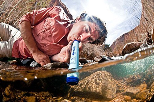backpacker using LifeStraw survival water filter