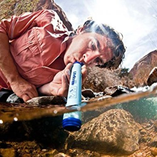 backpacker using LifeStraw survival water filter